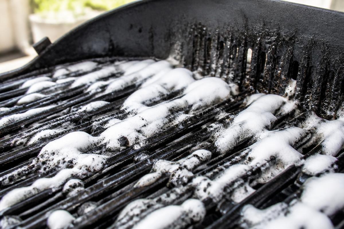 GreaseKiller foam clinging to greasy grill grates while it dissolves the grease